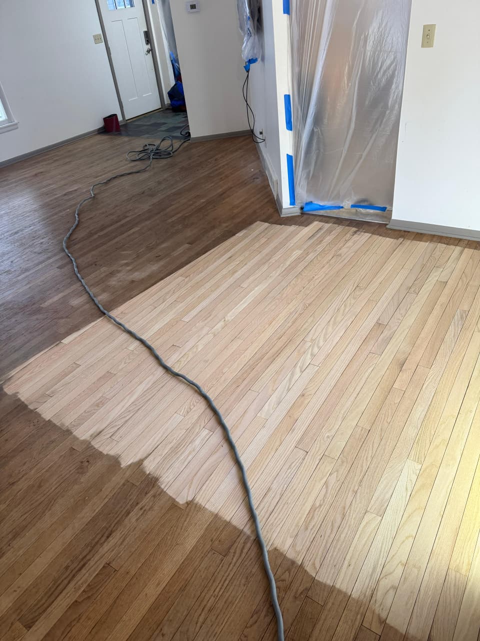 Wood staircase treads refinished and matched to hardwood floors in Rockford