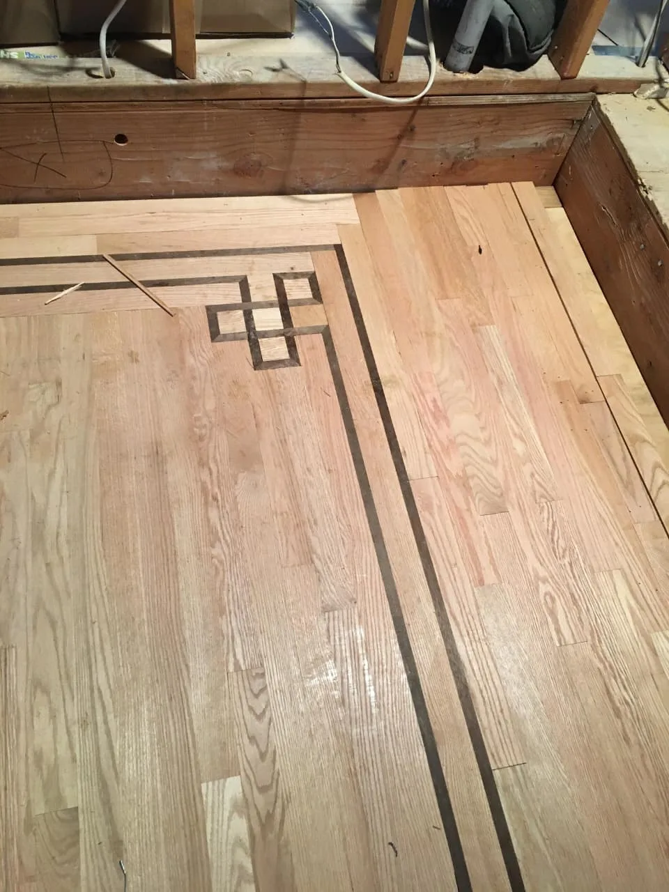 Professional hardwood floor installation — staircase transition Rockford IL