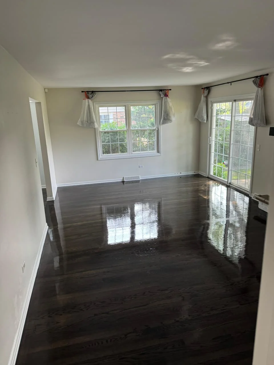 Before and after hardwood floor refinishing in Rockford home