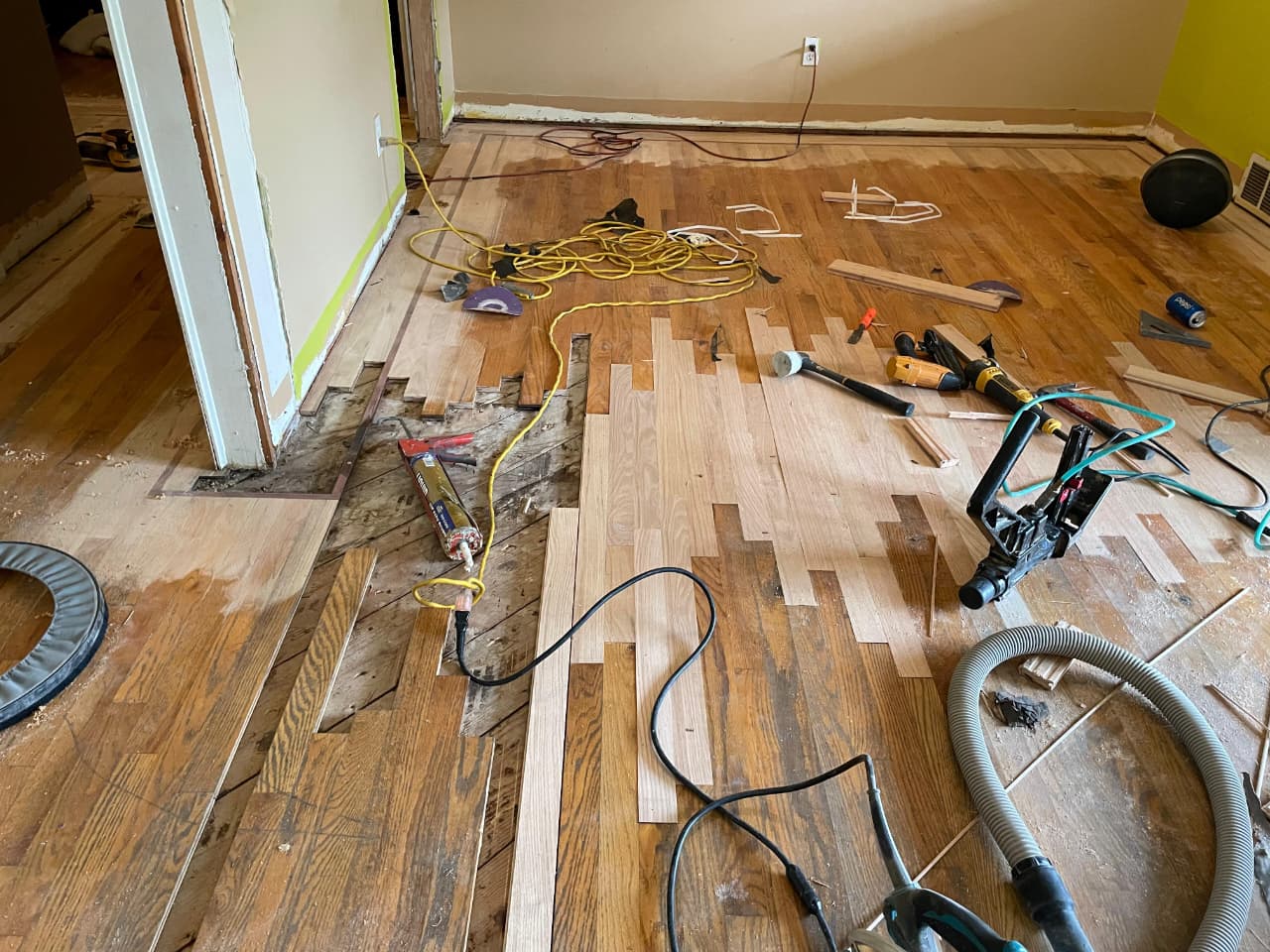 Floor board replacement and spot refinishing in Rockford home