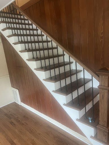 Rebuilt staircase with stained red oak treads and metal balusters