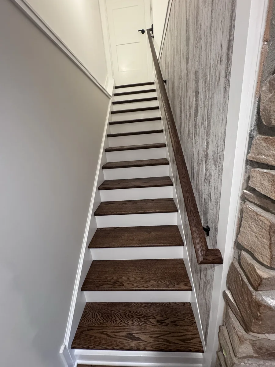 Dark-stained wooden stair treads with white risers in Pecatonica, IL